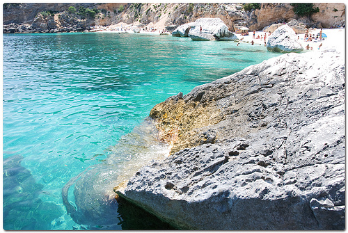 Baunei Sardinia rocky cove with tourists